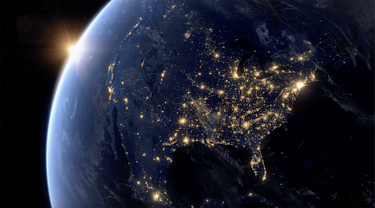 A captivating view of Earth at night, illuminated by countless shimmering lights emanating from its surface