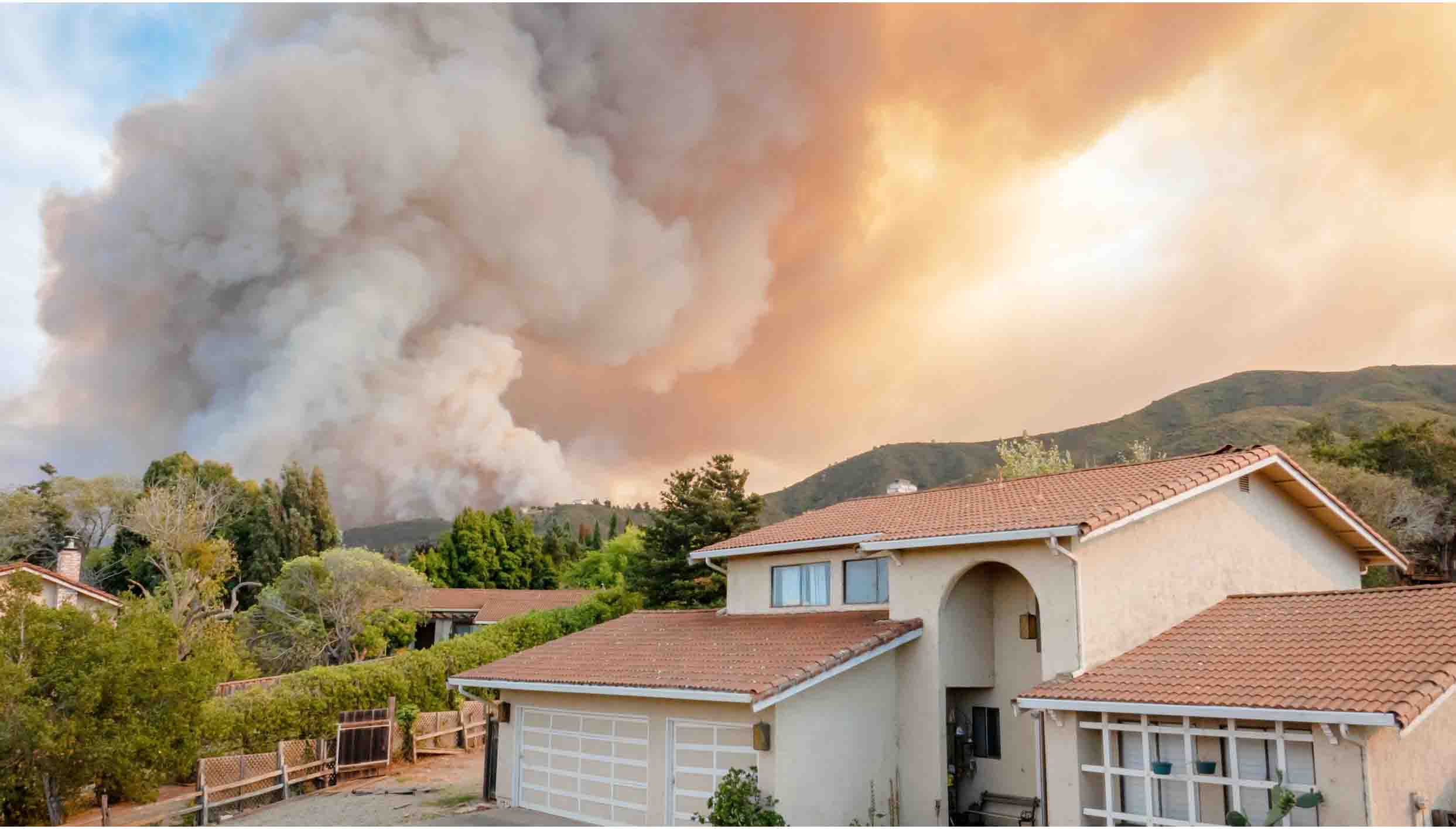 wildfire burning in the background, home in the foreground